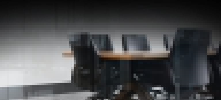 Empty boardroom with a table and office chairs