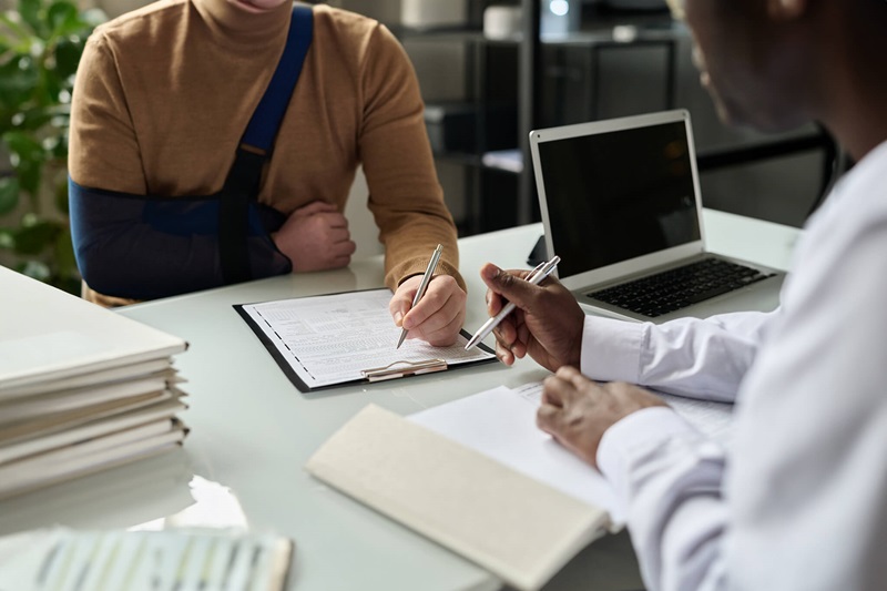 Disabled person reviewing paperwork on a clipboard