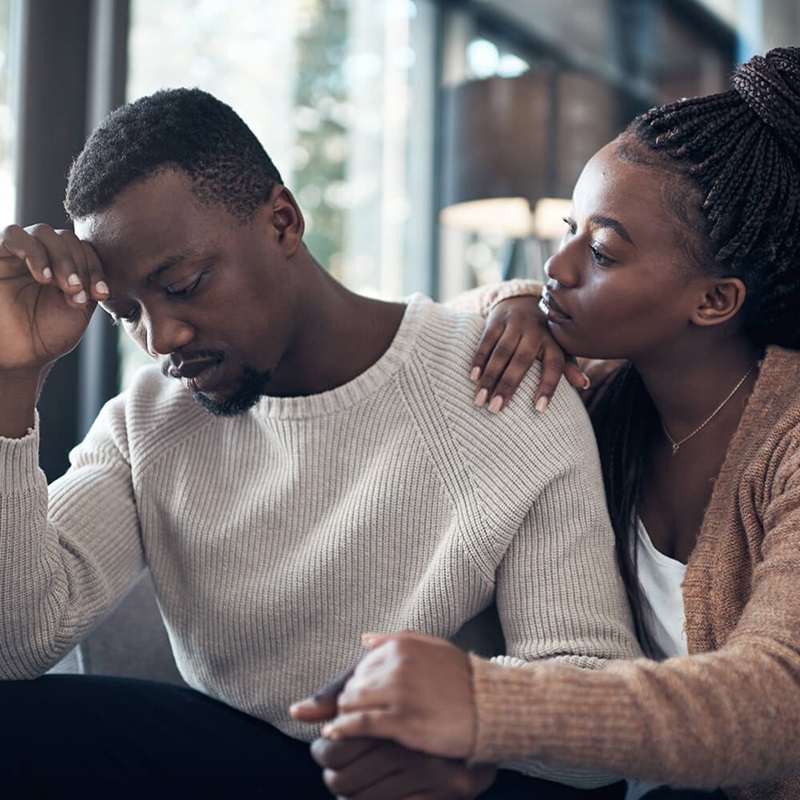 Worried couple comforting each other