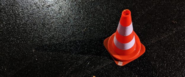 Orange traffic cone on asphalt