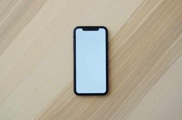 Photo of a blank mobile phone on a wooden surface